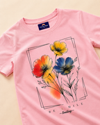 Baby pink T-shirt with close view floral print placed on the light beige background