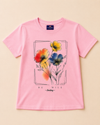 Baby pink T-shirt with floral print placed on the light beige background