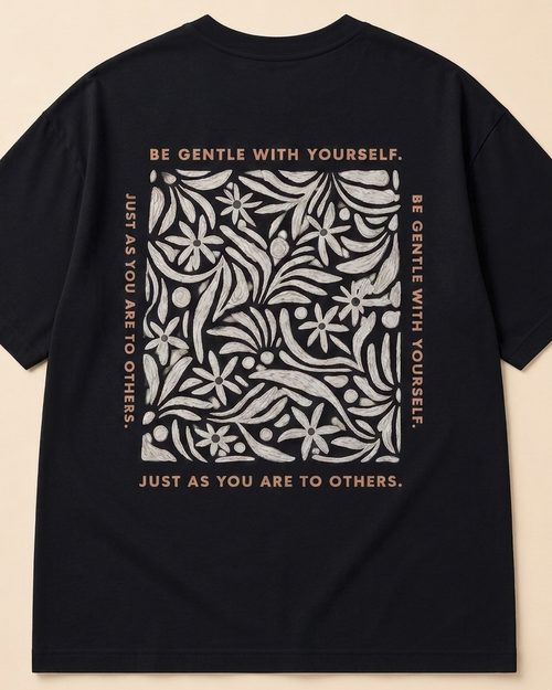 Be gentle print in oversized Black Oversized T-shirt placed on the light beige background
