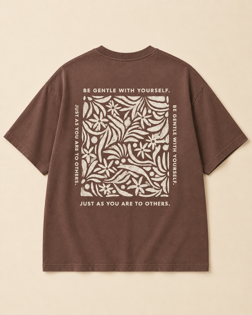 Be gentle print in oversized Brown Oversized T-shirt placed on the light beige background