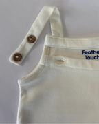 Beige overalls with button details on a light gray background