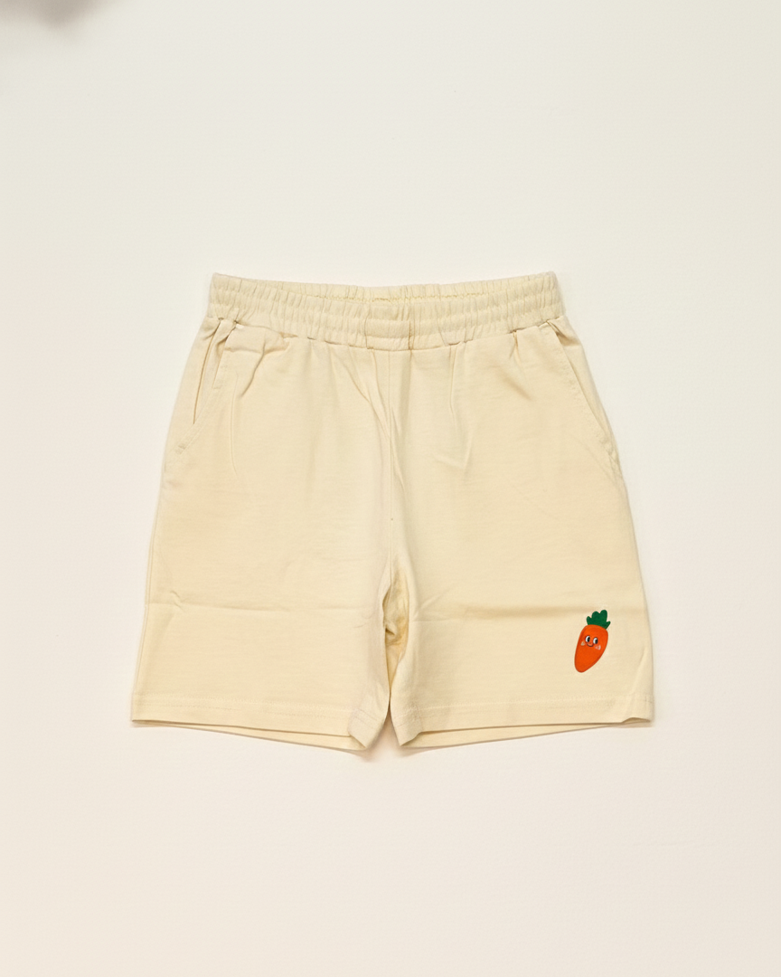 Beige shorts with a small embroidered design on a light beige background