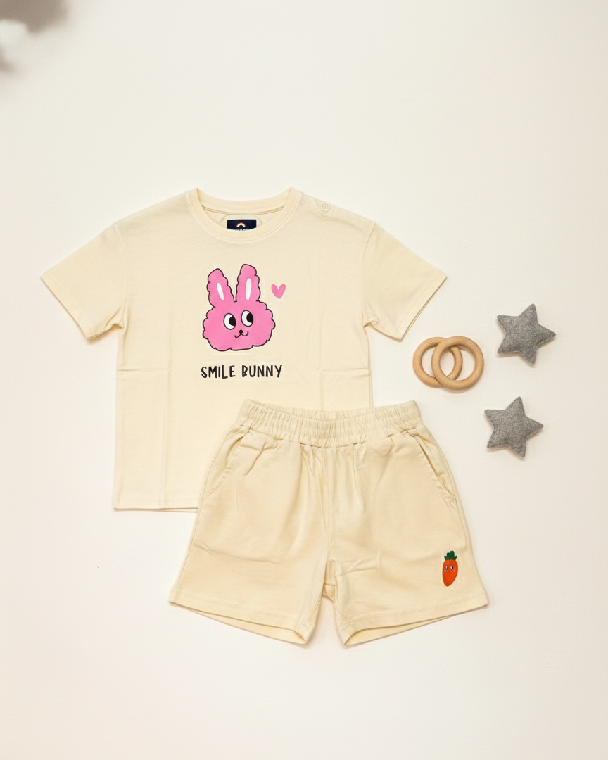 Beige t-shirt with a pink bunny design and shorts on a light beige background