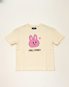Beige t-shirt with pink 'Smile Bunny' graphic on a white background