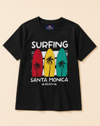 Black T-shirt with surfing beach  print placed in light beige background