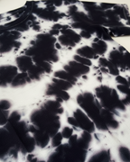 Black and white tie-dye pattern on a fabric swatch.