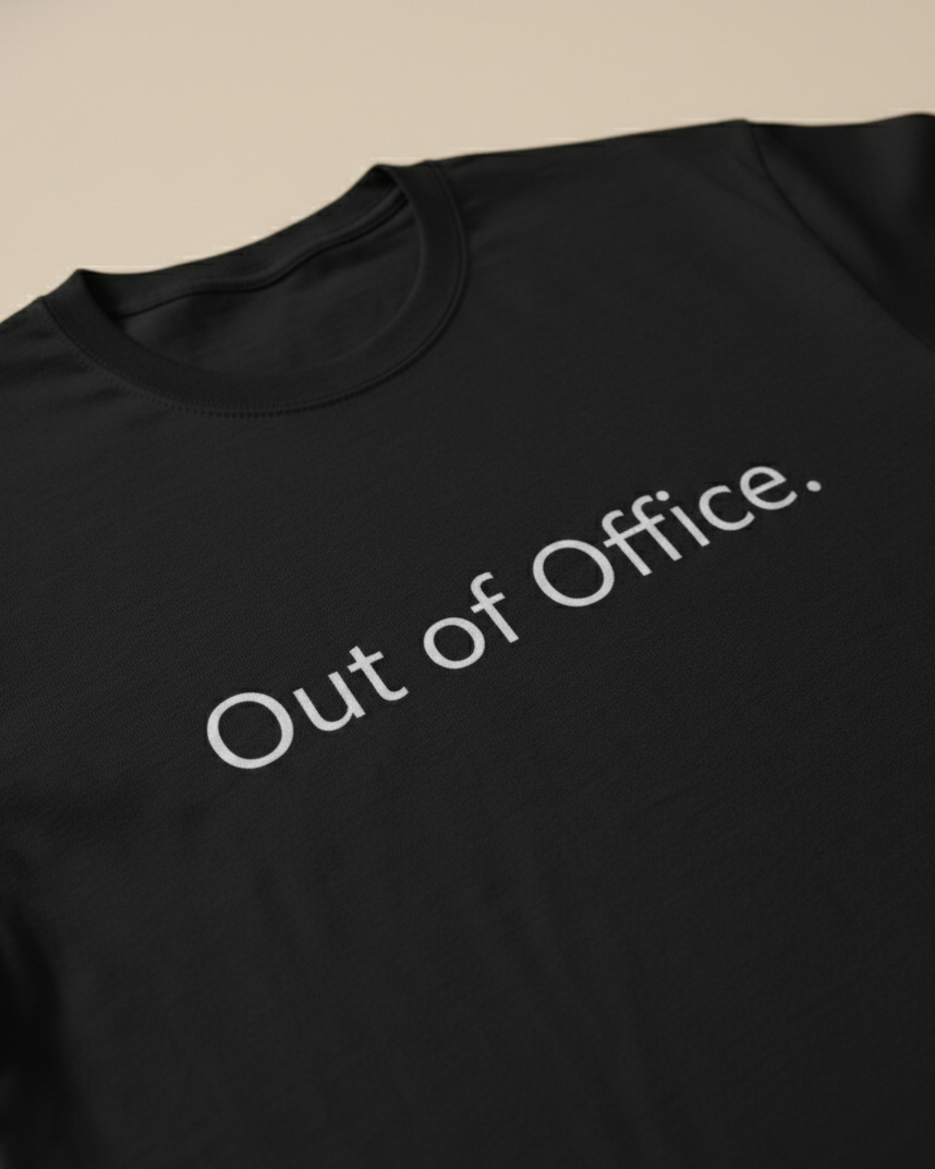 Black t-shirt with 'Out of Office' text on a beige background.