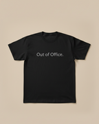 Black t-shirt with 'Out of Office' text on a beige background