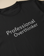 Black t-shirt with 'Professional Overthinker' text on a plain background