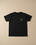 Black t-shirt with a bee graphic and 'Bee Kind' text on a beige background