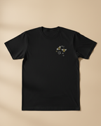 Black t-shirt with a small graphic on a beige background