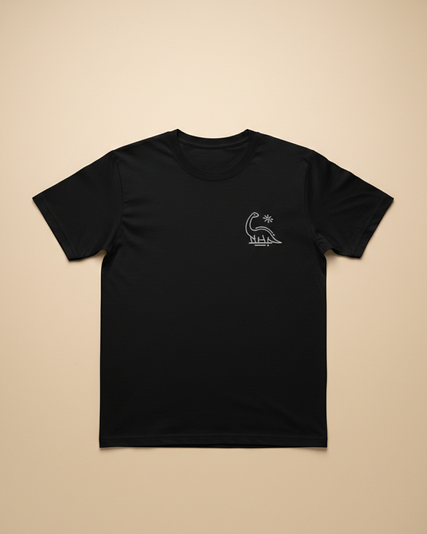 Black t-shirt with a small white logo on a beige background