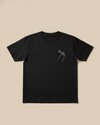 Black t-shirt with a white floral design on a beige background