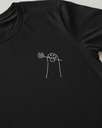 Black t-shirt with a white floral design on a light gray background