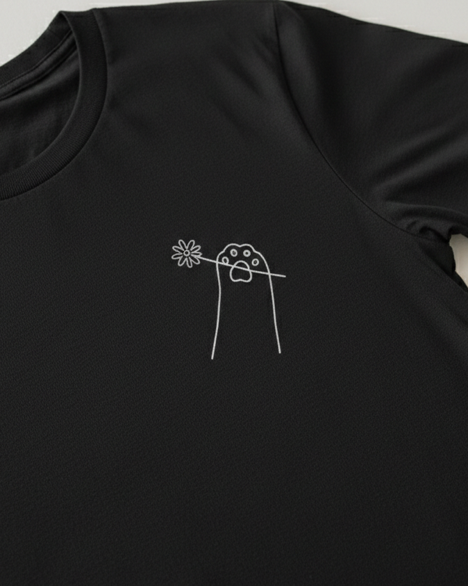 Black t-shirt with a white floral design on a light gray background