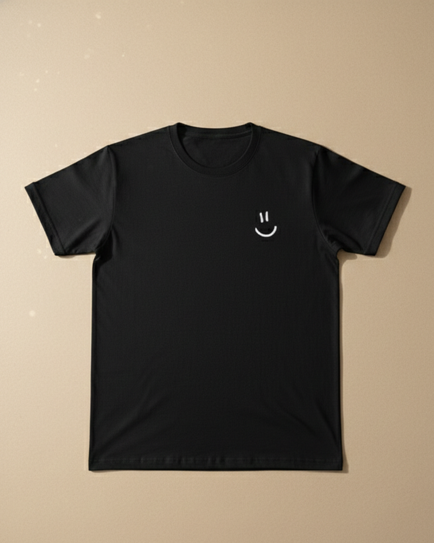 Black t-shirt with a white smiley face design on a beige background