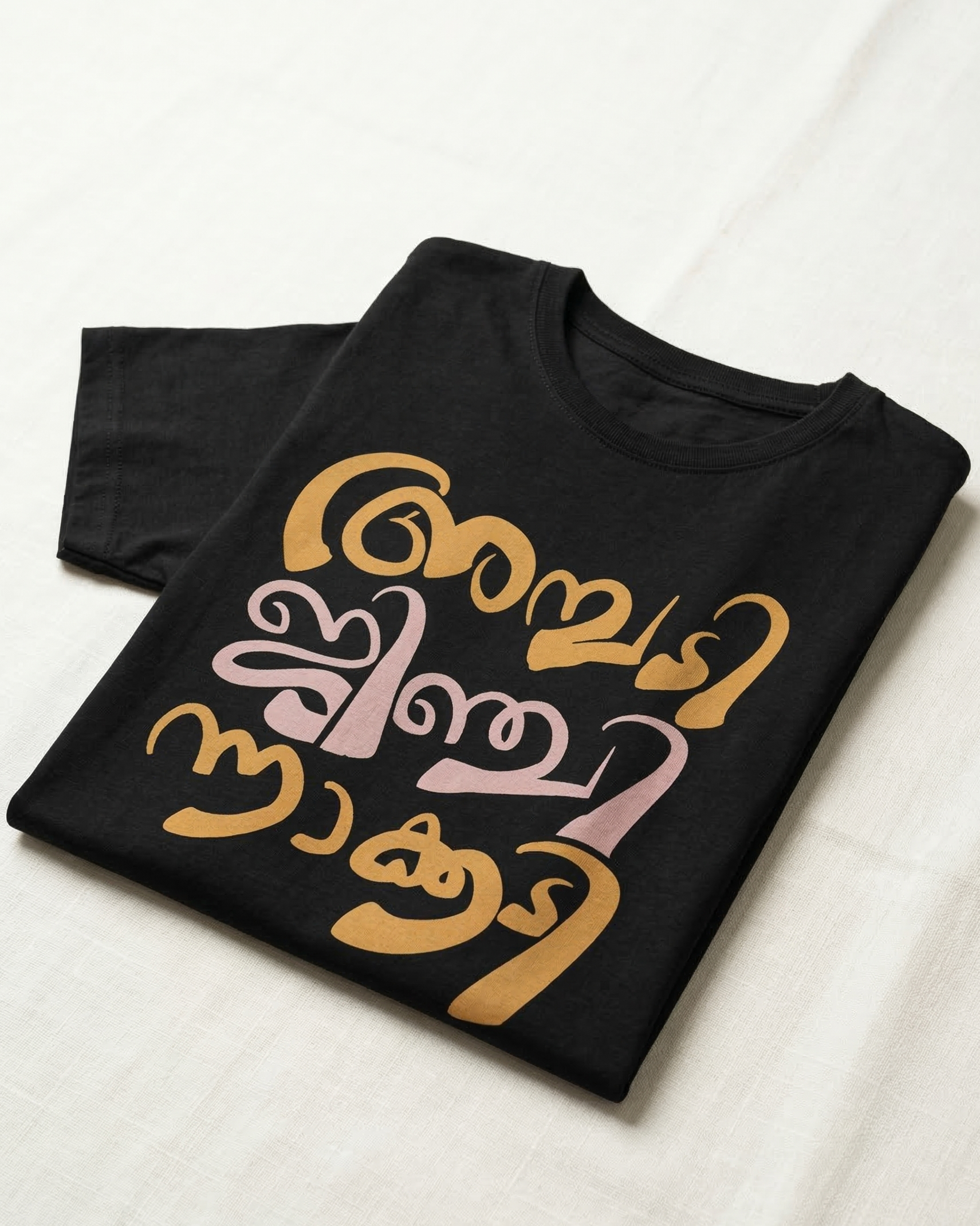 Black t-shirt with colorful text design on a white surface