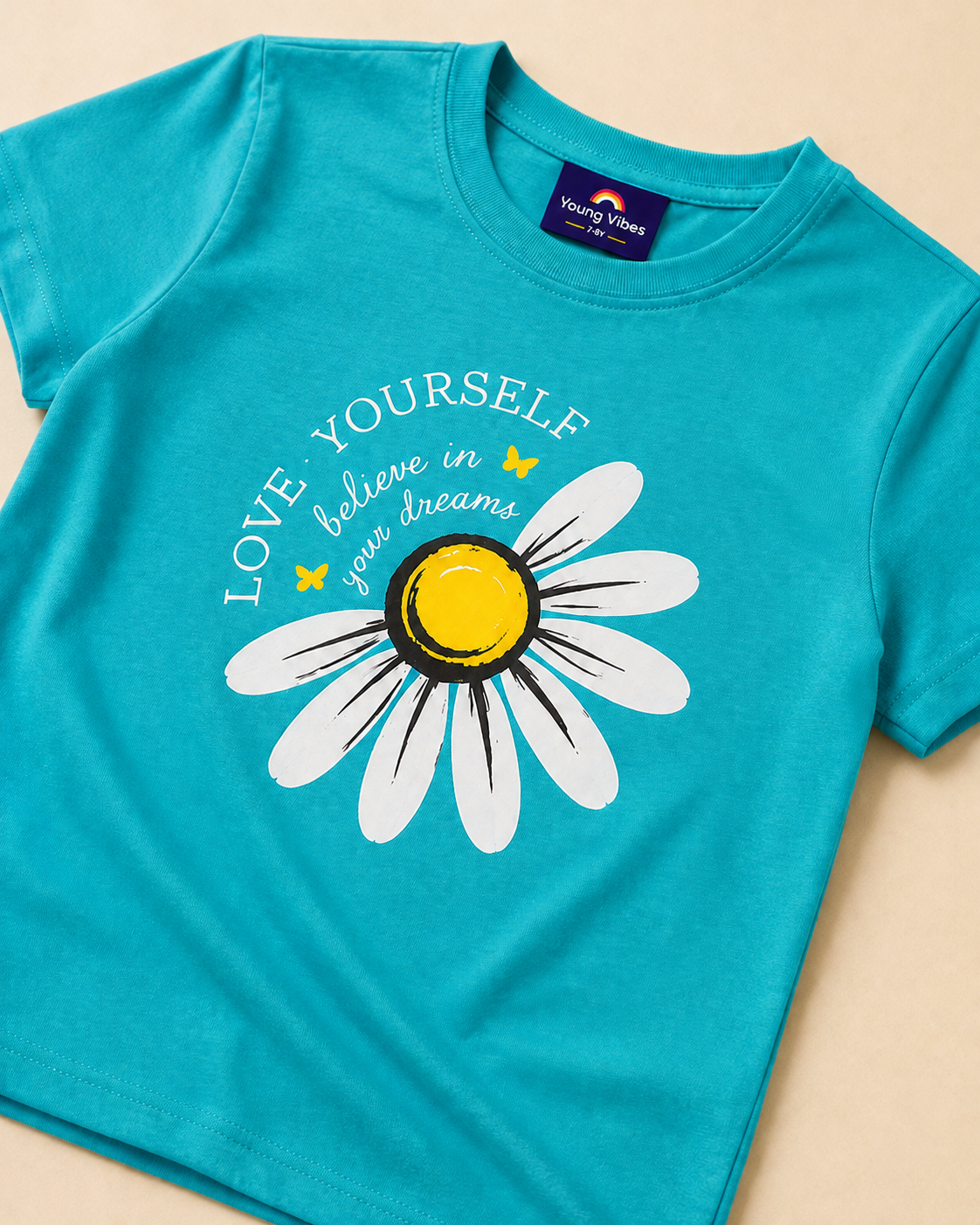 Blue  Green T-shirt with Sunflower print placed on the light beige background