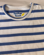 Blue and white striped garment with 'Feather Touch' logo on a white background