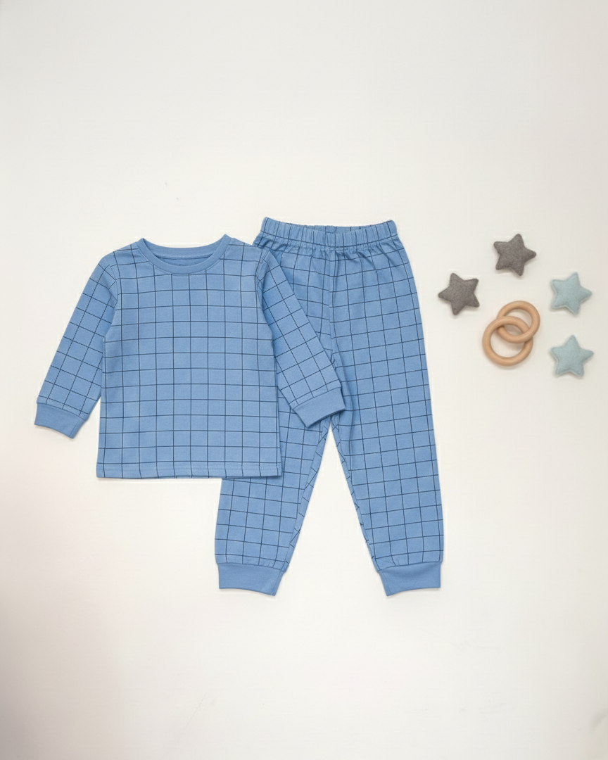 Blue checkered pajama set with baby toys on a white background