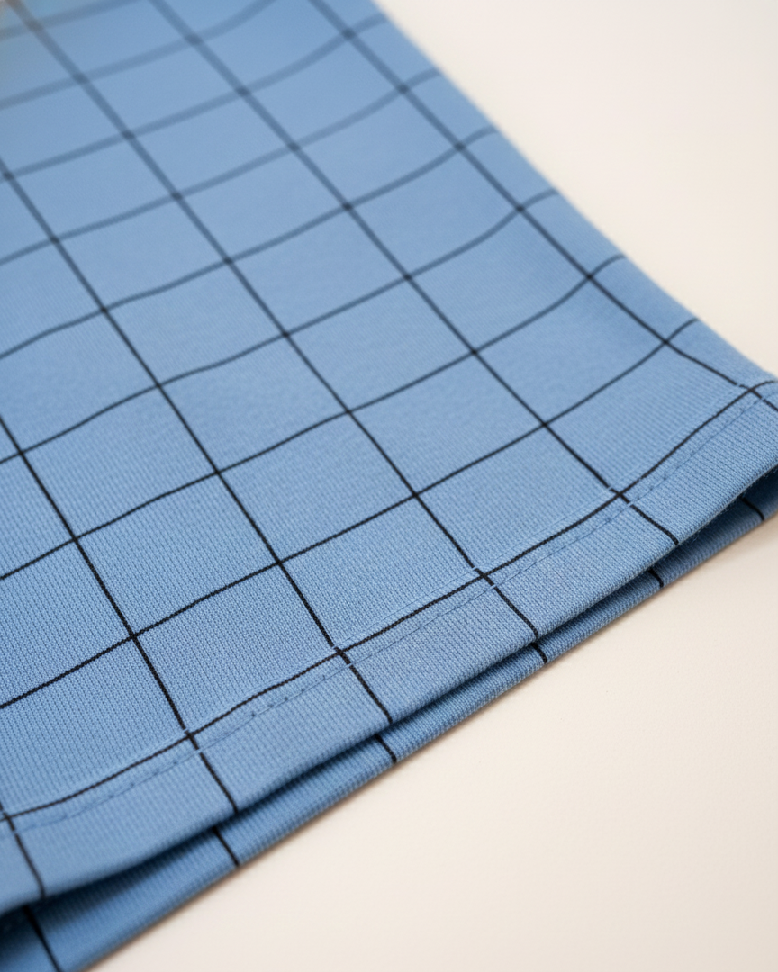 Blue fabric with a grid pattern on a light background