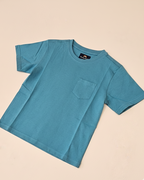 Blue t-shirt with a pocket on a beige background