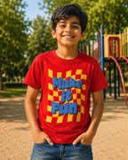 Boy wearing a Red colour T shirt with Make it fun print standing in park