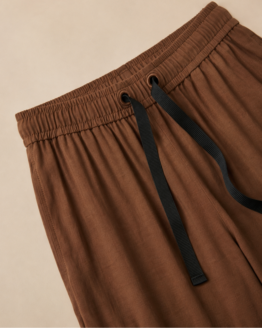 Brown Palazzo Pant closeup view laid on the beige background
