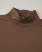 Brown turtleneck sweater on a light gray background