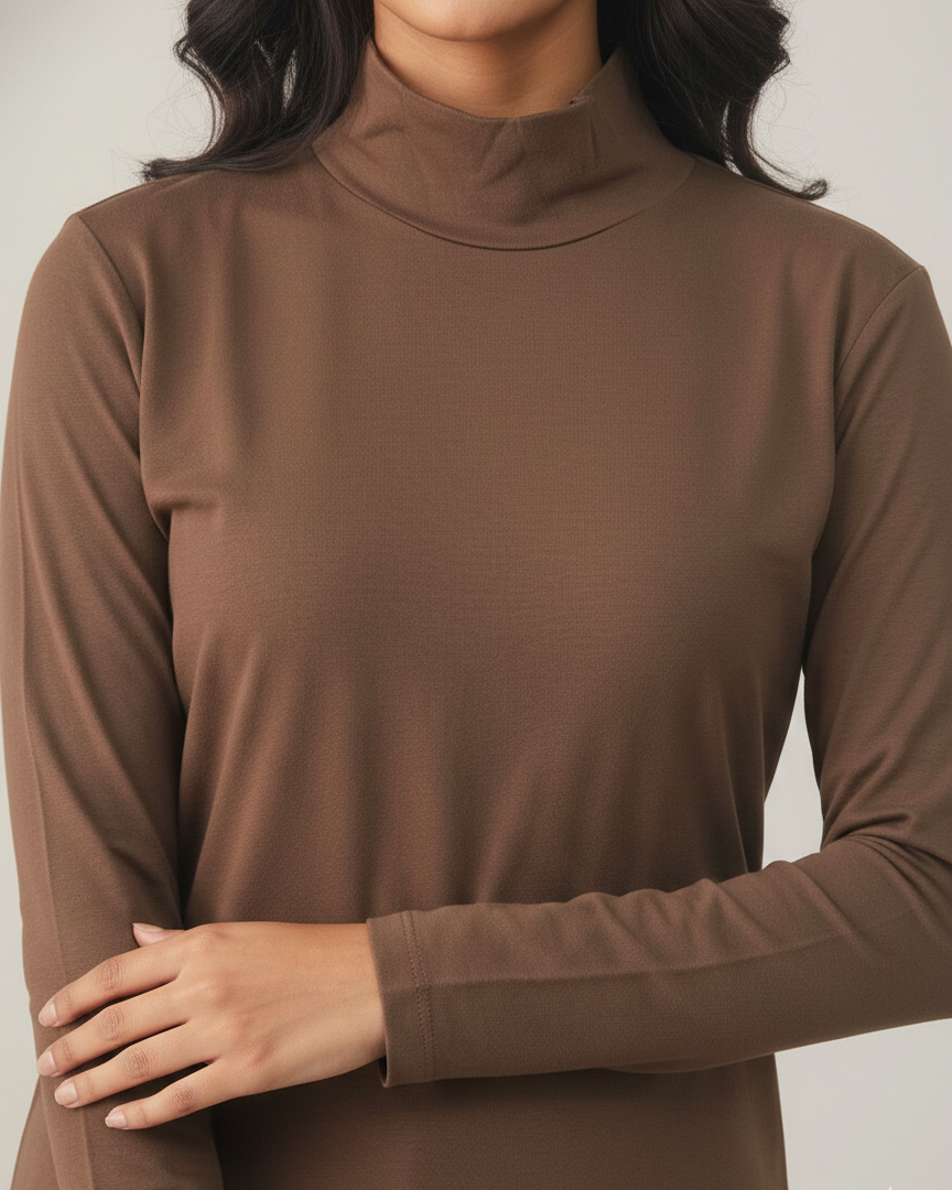 Brown turtleneck sweater worn by a person on a plain background