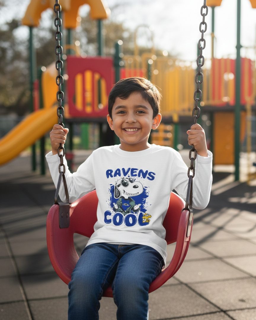 Child on a swing at a playground wearing a sweatshirt with a sports team logo.