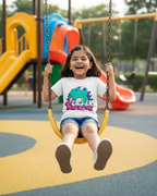 Child on a swing at a playground with colorful equipment in the background.