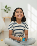 Child playing with colorful blocks indoors.