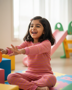 Child playing with colorful blocks on a mat indoors