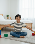 Child playing with colorful blocks on a rug in a bedroom