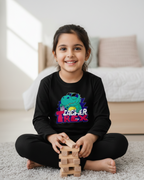 Child playing with wooden blocks in a room with a dinosaur-themed shirt