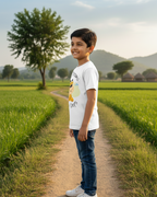 Child standing on a dirt path in a green field with mountains in the background