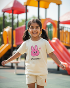 Child wearing a 'Smile Bunny' t-shirt on a playground