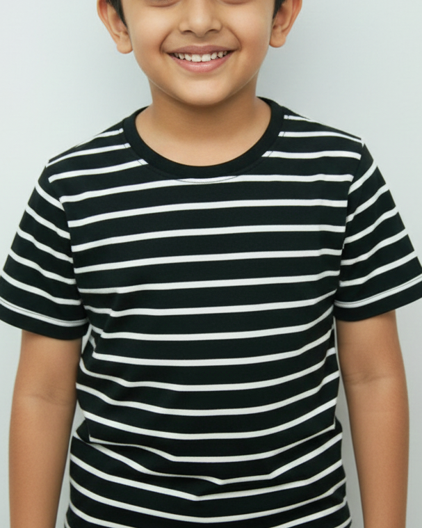 Child wearing a black and white striped shirt against a plain background