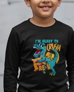 Child wearing a black long-sleeve shirt with a colorful dinosaur graphic and text.