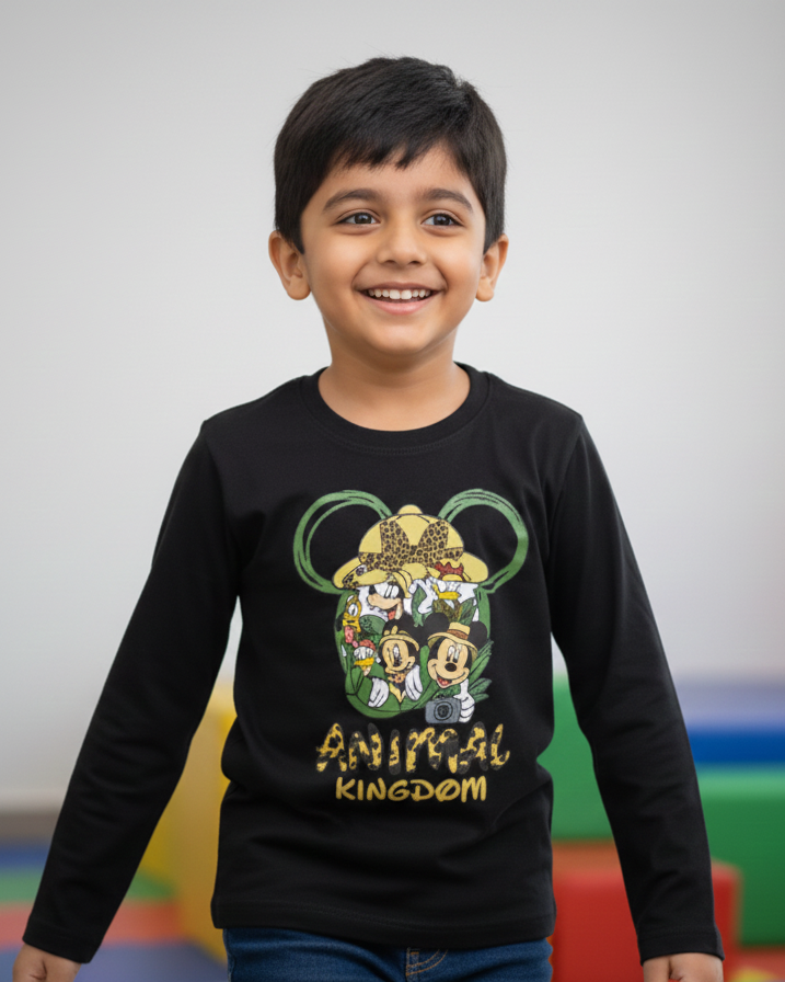 Child wearing a black long-sleeve shirt with a colorful graphic design, standing in an indoor play area.