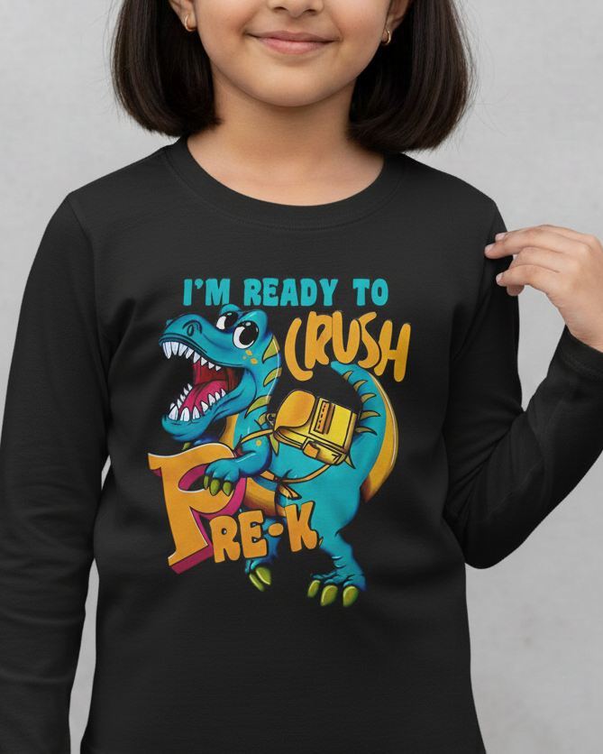 Child wearing a black long-sleeve shirt with a dinosaur graphic and text on a gray background
