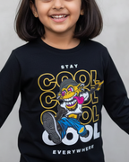 Child wearing a black long-sleeve shirt with a graphic design and text on a plain background