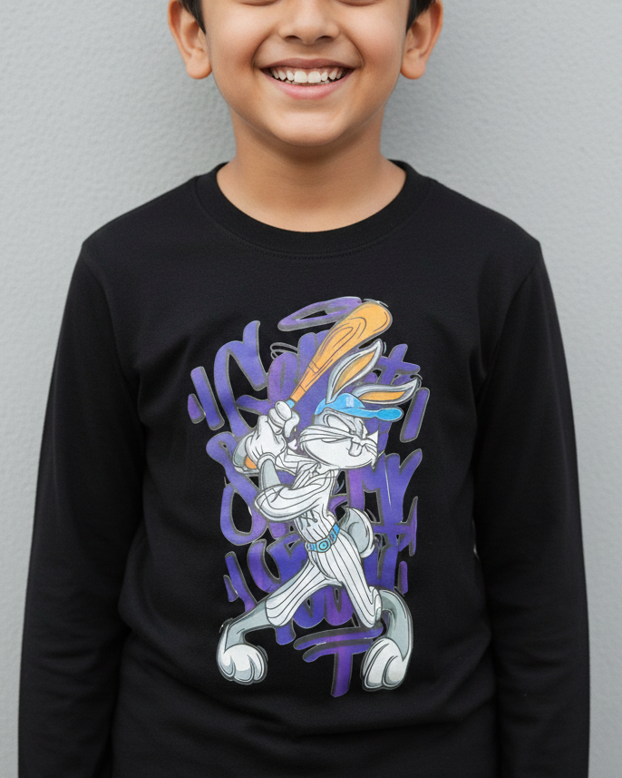 Child wearing a black long-sleeve shirt with a graphic design on a gray background