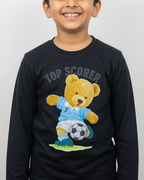 Child wearing a black long-sleeve shirt with a teddy bear graphic and 'Top Scorer' text on a white background