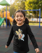 Child wearing a black shirt with a Minnie Mouse graphic on a playground.
