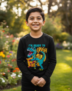 Child wearing a black shirt with a colorful dinosaur graphic in a garden setting