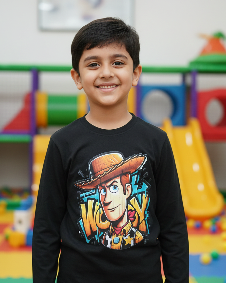 Child wearing a black sweater with a colorful graphic design in an indoor playground.