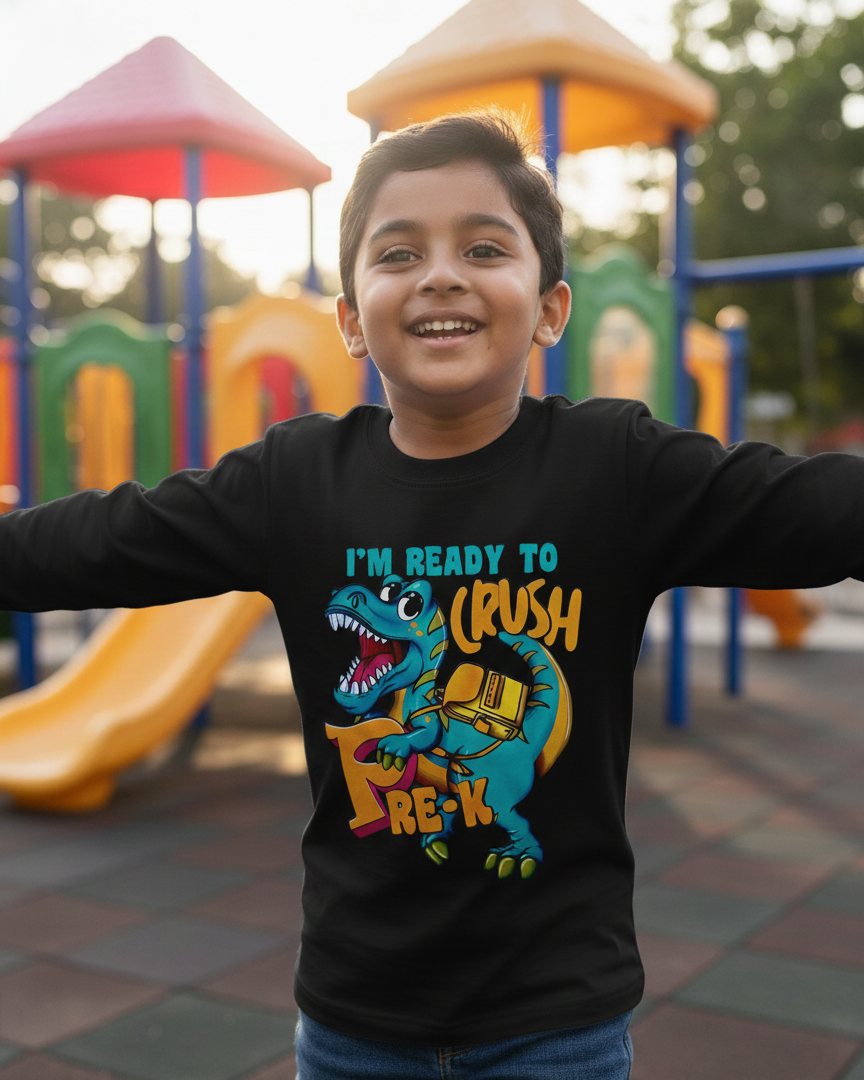 Child wearing a black t-shirt with a dinosaur graphic and text at a playground.