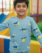 Child wearing a blue shirt with vehicle prints in an indoor playground setting